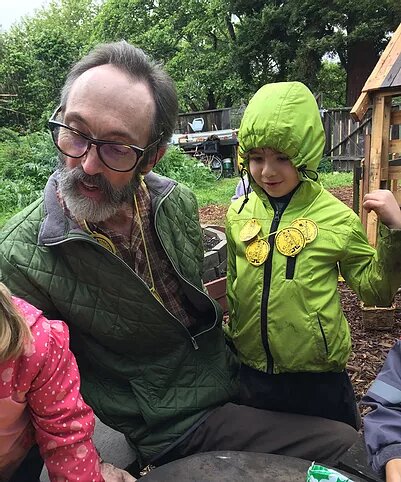 Author teaching two children in the forest school