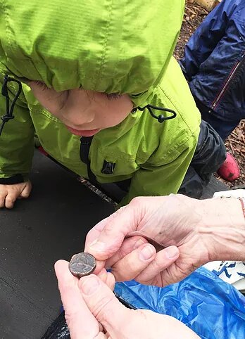 Author showing child a Kushan coin